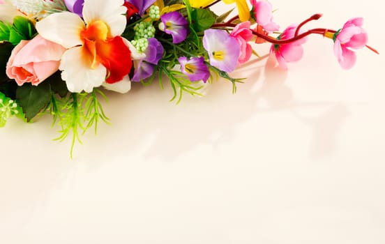 composition of artificial beautiful flowers on beige background