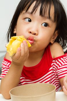 Asian Chinese little girl eating durian fruit