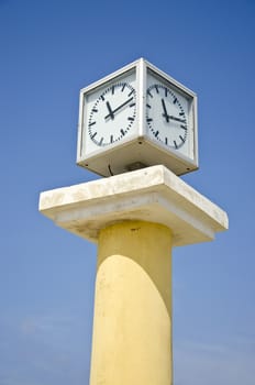 clock cube on vintage classic column and blue sky background, Greece