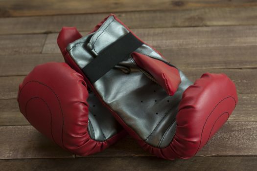 pair of boxing gloves on a wooden floor