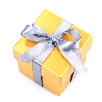 yellow gift box with silwer ribbon and bow isolated on white top view