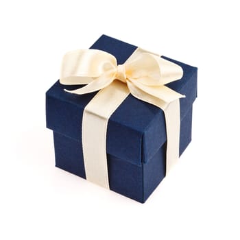 dark blue gift box with golden ribbon and bow isolated on white top view