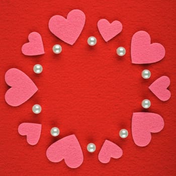 Frame with hearts and pearls on a red background