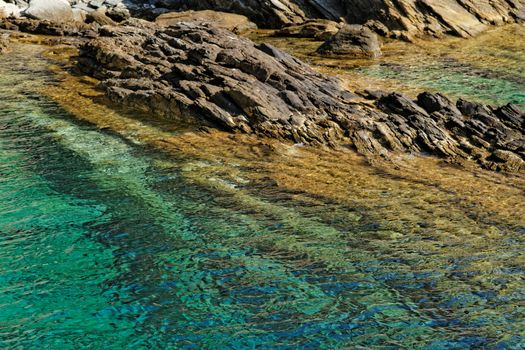 Photo of rock in the blue sea 