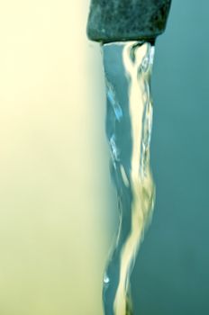 Tap of running water isolated on grey background