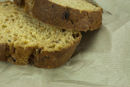 Cut fresh wholemeal bread on a sheet of brown paper