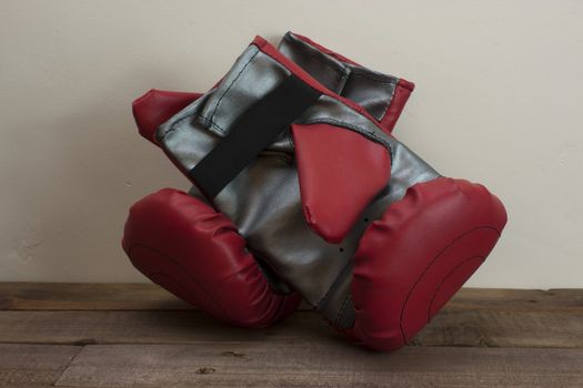 pair of boxing gloves on a wooden floor