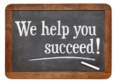 We help you succeed - marketing text on a vintage slate blackboard