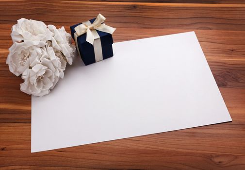 Greeting card with white flowers and a blue gift box