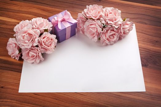 Greeting blank card with pink roses and purple gift box