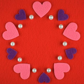 Frame with hearts and pearls on a red background