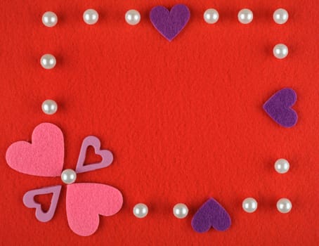 Frame with hearts and pearls on a red background