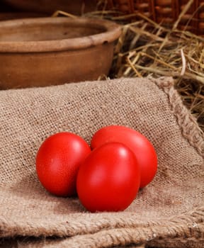 three red easter eggs at home backgraund