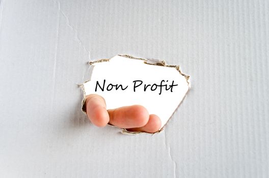 Hand and text Non Profit for text on the cardboard background - business concept