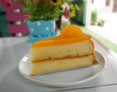 Orange cake, cut into triangles. The outer coat with orange marmalade.                               