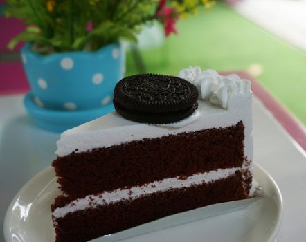 Chocolate cake cut into triangles, coated with creamy white on the outside.                              