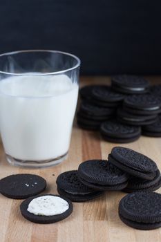 Chocolate sandwich cookies with vanilla creme filling and milk.