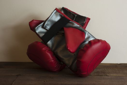 pair of boxing gloves on a wooden floor