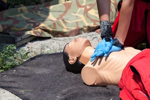 Cardiopulmonary resuscitation (CPR) being performed on a medical-training manikin