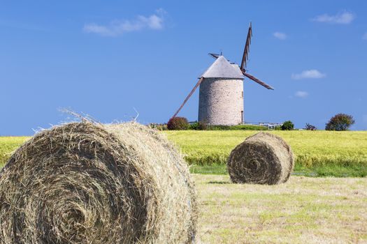 Windmill, wheat field and straw, France, Europe.