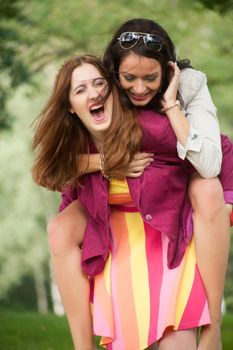 Two girls are having a lot of fun in the forest