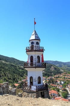 Close up front view of wooden tower building with three balcony in clear sky.