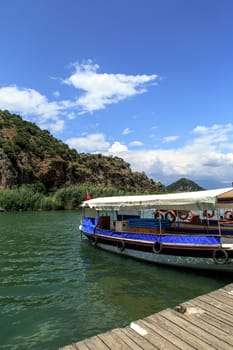 DALYAN, TURKEY - MAY 31, 2015 : Boats for touristic boat trips in the river between Koycegiz Lake and Iztuzu Beach in Dalyan.