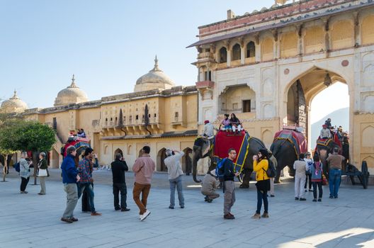 Jaipur, India - December 29, 2014: Tourists enjoy elephant ride in the Amber Fort on December 29, 2014, Amber Fort was built by Raja Man Singh I  in Jaipur, Rajasthan, India.