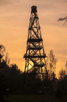 Silhouette of tall forest fire watch tower