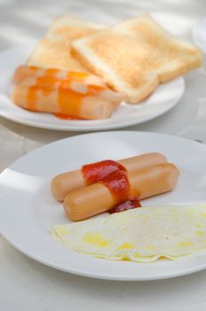 sausage with  sauce and  fried egg  on a plate