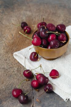 fresh cherries on wooden table  background