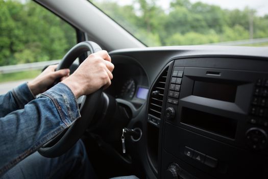 hand close up of a man driving a car