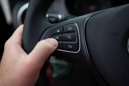 hand close up of a man driving a car