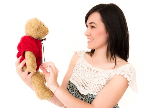 Beautiful Young Woman in Studio Shot Holding a Teddy Bear Toy on White Background