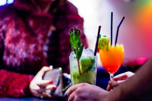 Elegant Woman Pays with Her Wallet for Cocktails While Bartender Serving