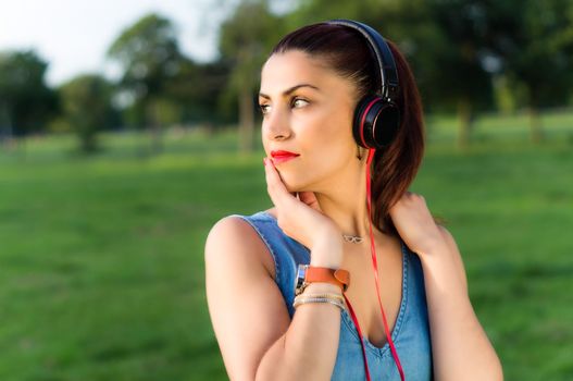 Woman with Headphones in the Park Looking Away