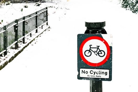 No Cycling Sign in a Park, Snowy Day
