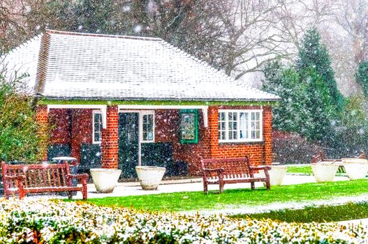 Redbrick House in a Park. Christmas Scenery and Fresh Snow. Cloudy Day. Battersea Park, London