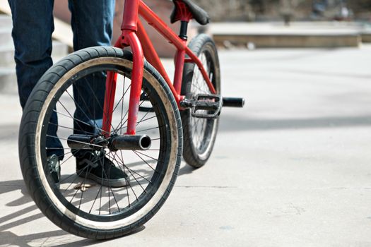 BMX bike rider parked at the skate park. Shallow depth of field.