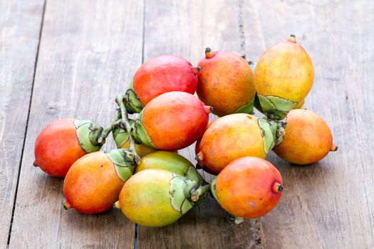 Beautiful Royal Palm seed fruit on wooden plate