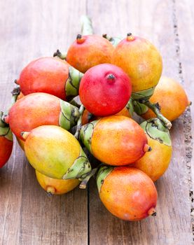 Beautiful Royal Palm seed fruit on wooden plate