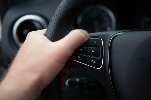 hand close up of a man driving a car