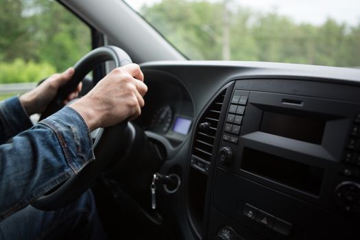 hand close up of a man driving a car