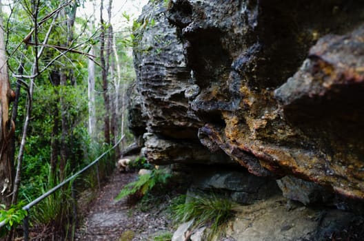 The fence trail passing rugged rock formations at Hazelbrook, Blue Mountains, Australia.