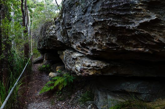 The fence trail passing rugged rock formations at Hazelbrook, Blue Mountains, Australia.