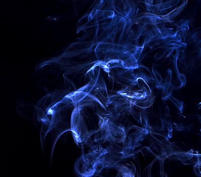 Blue smoke swirl on black background.