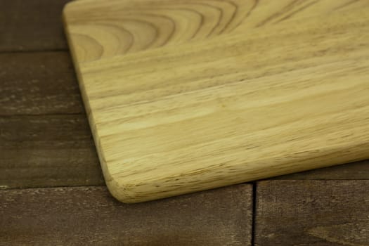 Wooden chopping board on an old table