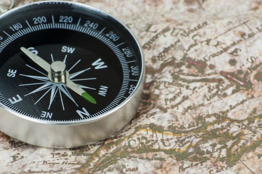 Close up of a compass on an old map