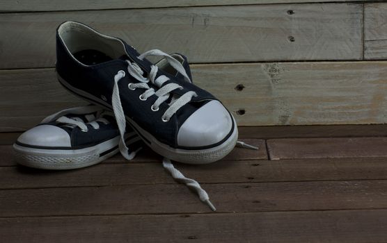 Old worn shoes left on a wooden floor