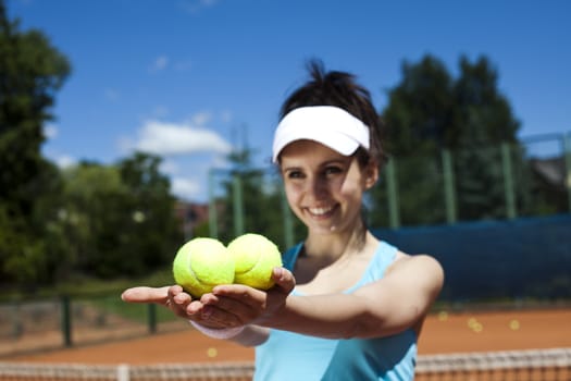 Girl playing tennis on the court